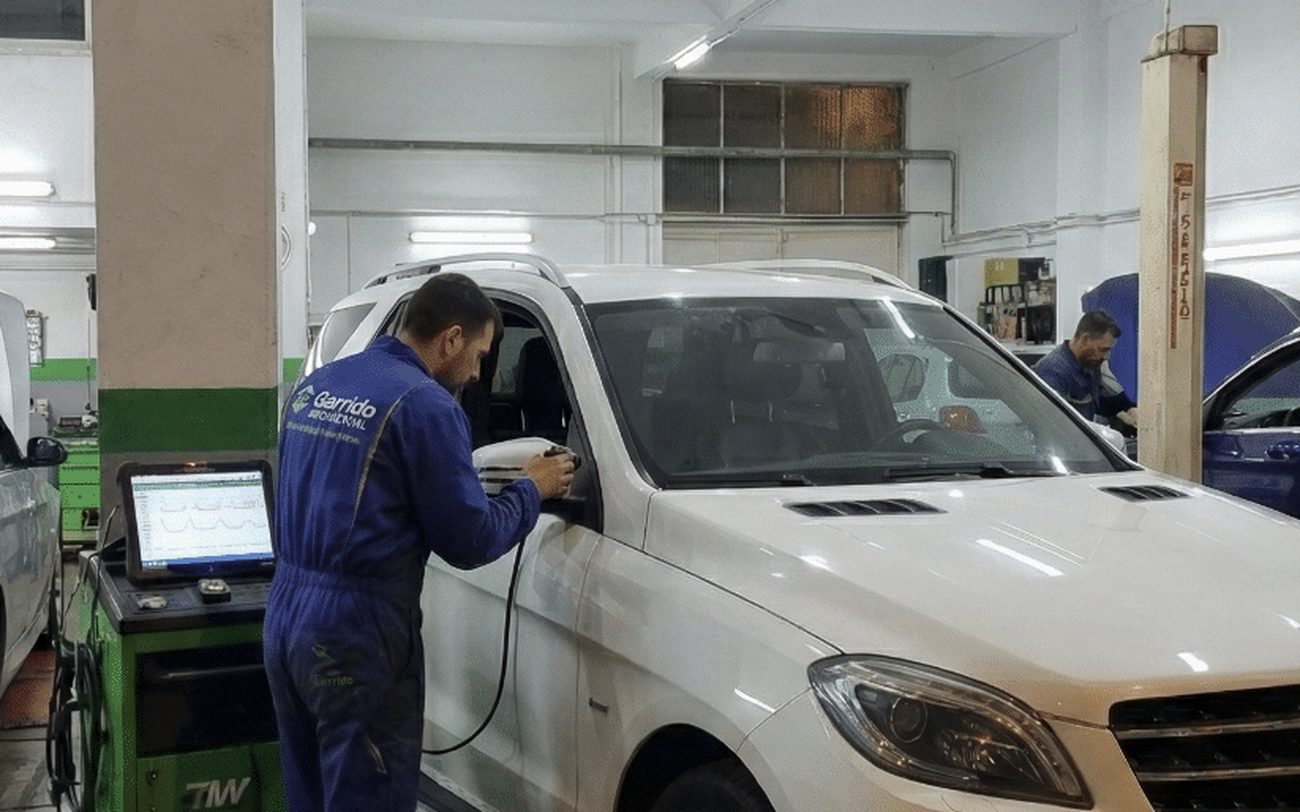 Técnico de Taller Garrido con el equipo de diagnosis conectado a un coche